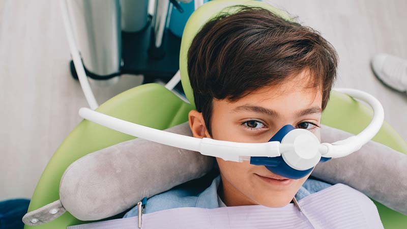 Kid dental sedation in dental chair