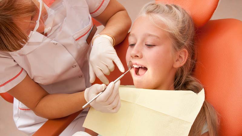 Girl at dentist for tooth extraction