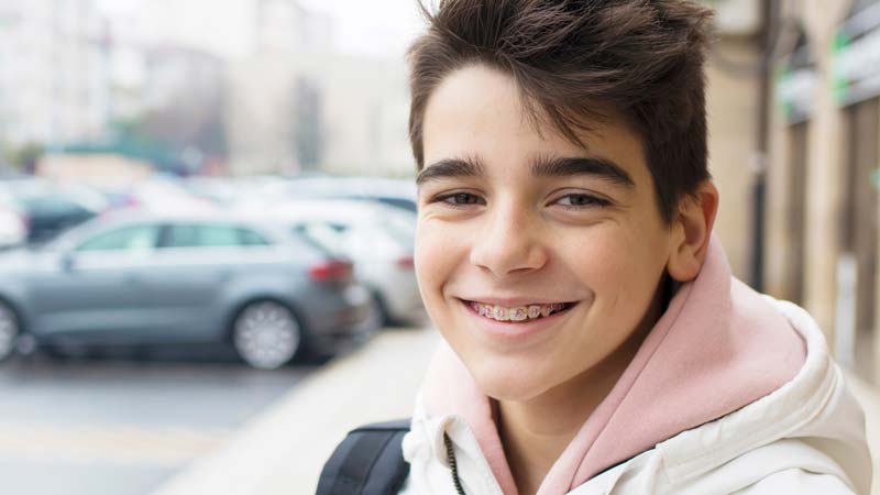 Boy with Braces Outside Dental Office