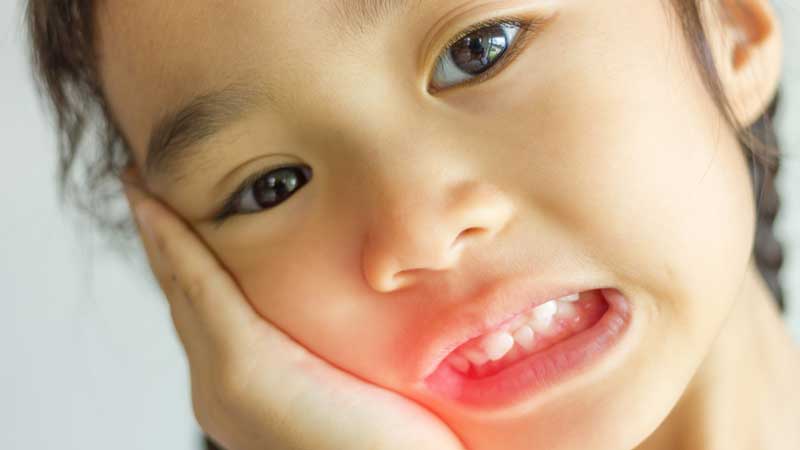 Child Holding Mouth From Toothache