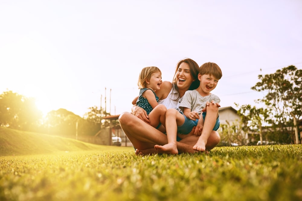 Laser Dentistry in St. Charles and Wheaton mom smiling with her two kids